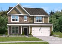 Two story home with stone and siding exterior and attached garage at 211 Coronado Ave # 57, Matthews, NC 28104
