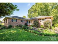 Brick ranch house with a landscaped lawn and walkway at 1890 Rhyneland Rd, Lincolnton, NC 28092