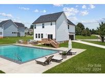 Relaxing backyard oasis featuring a refreshing pool, spacious patio, and comfortable lounge chairs at 103 Dublin Ct, Statesville, NC 28677
