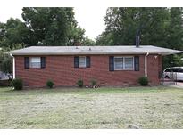 Brick ranch house with a well-maintained lawn at 440 Frank Dr, Charlotte, NC 28215