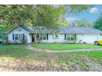 Ranch home with mature landscaping and a two-car garage at 8018 Maxwelton Dr, Huntersville, NC 28078