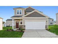 Two-story home with attached garage and landscaping at 743 Olde England Dr, Lincolnton, NC 28092