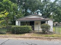 Small house with white siding and a chain-link fence at 272 Malvern Dr, Concord, NC 28025