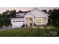 Modern farmhouse exterior with attached garage at 7567 Baybrooke Ln # 35, Harrisburg, NC 28075