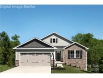 House exterior; two-story home with stone accents and three-car garage at 467 Hollis Dr # 0055, Lancaster, SC 29720