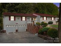 Ranch-style home with a red roof and attached garage at 4120 Statesville Blvd, Salisbury, NC 28147