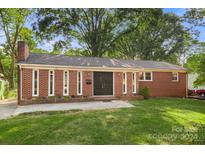 Brick ranch house with a double front door and well-manicured lawn at 1573 Timberlake Dr, Shelby, NC 28150