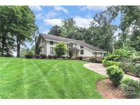 House with a large front yard, landscaping, and driveway at 3208 Sedgefield Rd, Statesville, NC 28625