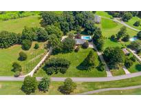 Aerial view showcasing home's location and landscaping at 3029 River Rd, Shelby, NC 28152