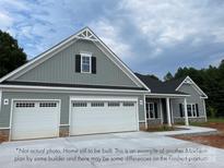 Two-story home with three-car garage and gray siding at 146 Falls Leaf Dr # 7, Troutman, NC 28166