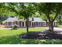 Brick ranch home with a classic design and well-maintained lawn at 2009 Echo Ln, Gastonia, NC 28052