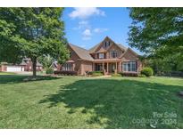 Brick house with a two-car garage and well-manicured lawn at 312 Wintergreen Ct, Kings Mountain, NC 28086