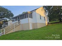 Cute bungalow with a screened porch and stairs at 38 Pine St, Great Falls, SC 29055