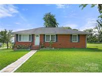 Brick ranch house with a well-maintained lawn and walkway at 117 Bolding St, Gastonia, NC 28052