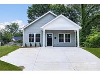 Gray house exterior with a white trim and a concrete driveway at 920 Holmes St, Salisbury, NC 28144