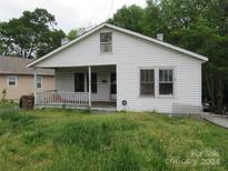 White house with a porch, situated on a grassy lot at 1146 Buffalo St, Shelby, NC 28150