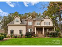 Two-story house with stone accents and a landscaped lawn at 124 Streamwood Rd, Troutman, NC 28166