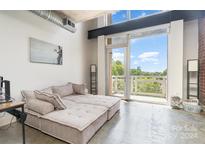 Living area with access to balcony and city view at 710 W Trade St # 515, Charlotte, NC 28202