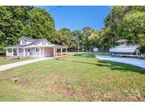 One story home with carport and boat in the yard at 60 Hunter Bridge Rd, Stony Point, NC 28678