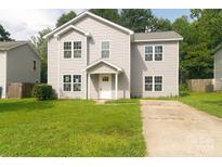 Two-story house with gray siding and a grassy lawn at 830 Oakshire Cir, Charlotte, NC 28214