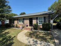 Brick ranch home with landscaped yard and carport at 836 S Cherry Rd, Rock Hill, SC 29732