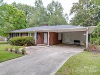 Brick ranch home with carport and landscaping at 610 Davis St, Lancaster, SC 29720