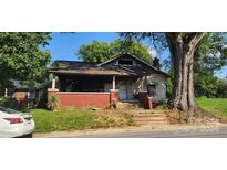 Brick house requiring renovations, features a front porch and needs significant repairs at 215 S Ervin Ave, Newton, NC 28658