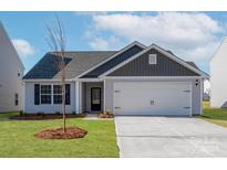 Charming one-story home with gray siding and a two-car garage at 146 Adams Tree Way, Troutman, NC 28166