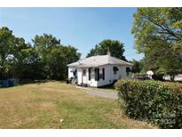 Small house with front yard and driveway at 110 Sims Pkwy, Harrisburg, NC 28075