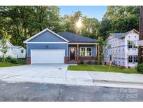 Newly built home with blue siding, brick accents, and a two-car garage at 354 Moore Ave, Mooresville, NC 28115