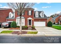 Brick front two-story home with attached garage and landscaping at 5300 Berkeley Pines Ln, Charlotte, NC 28277