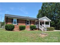 Brick ranch house with a covered front porch at 500 Doffin Ln, Gastonia, NC 28052