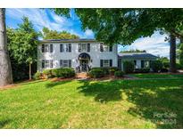 Two-story house with a white exterior, black shutters, and landscaped lawn at 12 36Th Nw Ave, Hickory, NC 28601