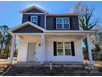 Two-story house featuring white siding, gray accents, and a front porch at 2707 Crescent Ln, Gastonia, NC 28052