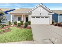 House exterior with gray siding, white garage door, and landscaping at 24601 Blue Heron Cir, Lancaster, SC 29720