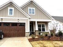 Two-story craftsman style home with a neutral exterior and brown double garage door at 173 Fulworth Dr, Concord, NC 28027