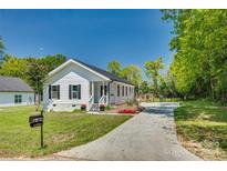 Newly built white house with black shutters and a manicured lawn at 102 Stanton St, Clover, SC 29710