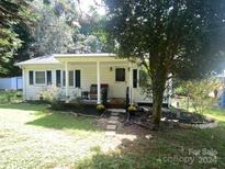 Charming ranch home with covered porch and well-maintained landscaping at 102 Aderholdt Rd, Bessemer City, NC 28016