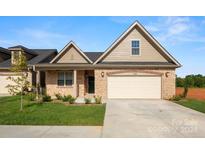 Craftsman style home with a two-car garage and landscaped lawn at 829 C Wynnshire Dr # 57, Hickory, NC 28601