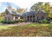 Brick house with a nice manicured lawn and landscaping at 860 Arrow Point Ln, Davidson, NC 28036