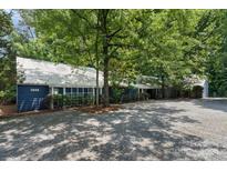 Blue house exterior with gravel driveway and landscaping at 1346 Hill Rd, Charlotte, NC 28210