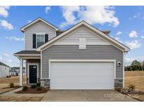 Two-story house with gray siding, white garage door, and landscaping at 731 Olde England Dr, Lincolnton, NC 28092