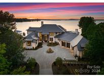 Luxury lakefront home with stone facade and fountain at 19125 Peninsula Point Dr, Cornelius, NC 28031