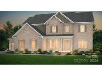 Two-story brick home with welcoming front porch and landscaping at 6104 Music Arbor Ln # 429, Huntersville, NC 28078