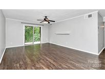 Living room with dark hardwood floors and sliding doors at 4754 Hedgemore Dr # T, Charlotte, NC 28209