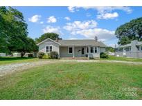Ranch-style house with covered porch and lawn at 115 Abernathy St, Mount Holly, NC 28120