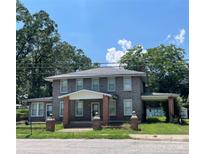 Brick two-story house with a front porch and attached carport at 309 Elm St, Marshville, NC 28103