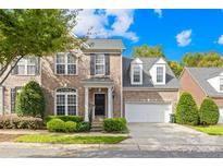 Brick two story house with attached garage at 10320 Berkeley Pond Dr, Charlotte, NC 28277