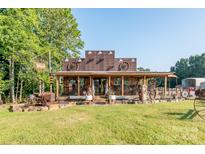 Rustic-style home with a large front porch and antique decor at 5067 E Dixon Blvd, Kings Mountain, NC 28086