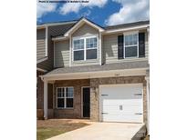Two-story townhome with neutral exterior and two-car garage at 5151 Tommy Ln # 1103, Stanley, NC 28164